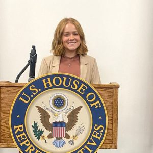 Rachel Pratt at a lectern for Congressman Neguse