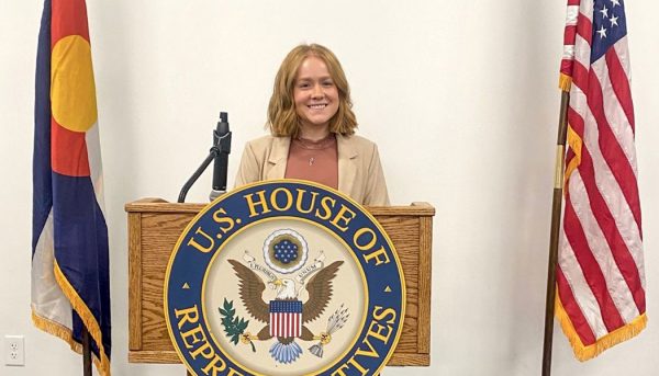 Rachel Pratt at a lectern for Congressman Neguse