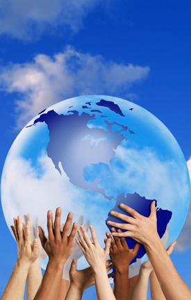 Diverse hands supporting a blue globe against a bright sky, symbolizing unity and global responsibility.